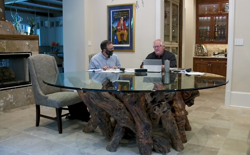 Reporter Mike Hammer and Mike Brandner Sr., brother of Scot Brandner, discuss Fr. Brian Highfill. Still from video report.