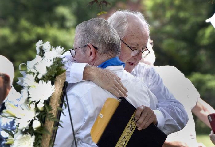 Joe Croteau, left, hugs Retired priest Rev. James Scahill after Scahill spoke at held a graveside memorial service for Joe's little brother Danny, the 13-year-old altar boy authorities determined was killed by his parish priest in 1972. (Don Treeger / The Republican) 6/28/2021
