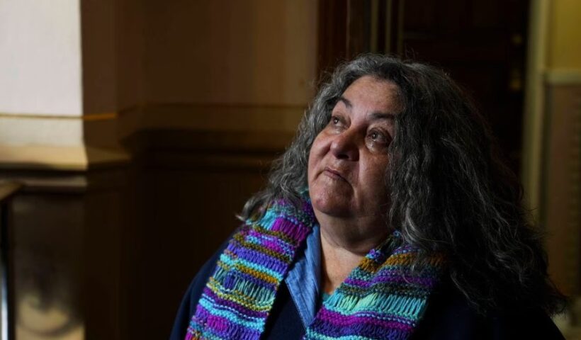 Linda Malat Tiburzi says a prayer and lights candles in honor of a friend and former classmate, Eddie Blair, who died before the trial of their former teacher in January 2023. Tiburzi, who dedicated her life to supporting abuse survivors, died Tuesday, Oct. 17, 2023, at age 62. (Kaitlin Newman / The Baltimore Banner)