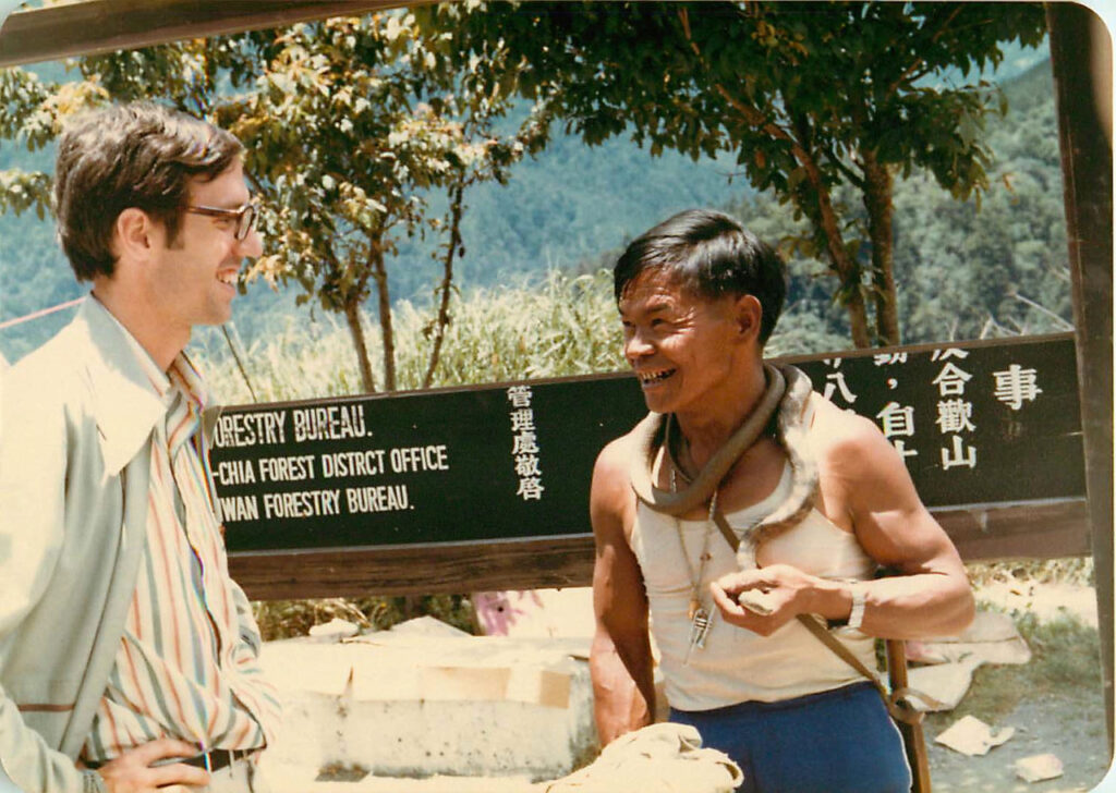 Fr. Jim Chevedden in Taiwan about 1975. “Talking to a seller of snake medicine. I drank two glasses of it but it didn’t cure my asthma. This fellow was formerly a guerilla soldier fighting the Red army on the Thai-China border.”