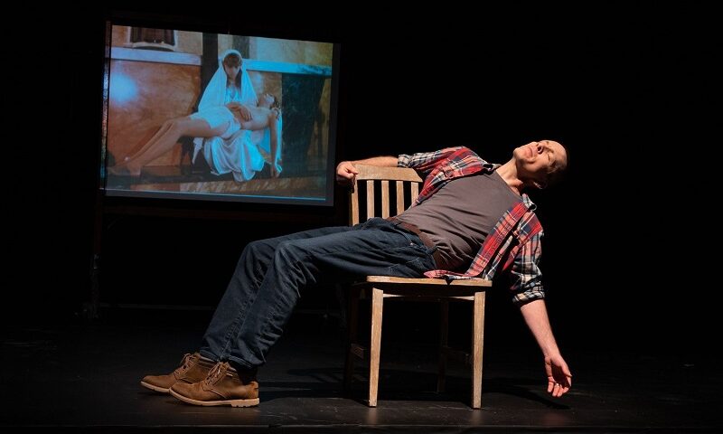 A scene from Jay Sefton's Unreconciled, with a film still from the passion play performed at Annunciation B.V.M. church in Brookline, Havertown, Greater Philadelphia in 1985. Courtesy of Jay Sefton.