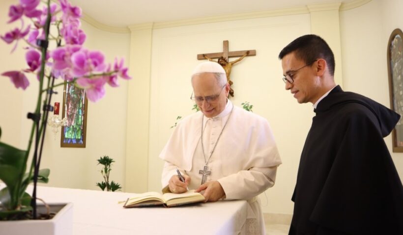 Pope Leo XIV signs the guest book at the Augustinian Order's headquarters in Rome in the days after his election, May 2025. From the Augustine Order's social media.