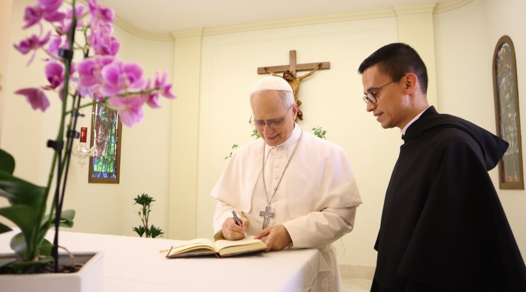 Pope Leo XIV signs the guest book at the Augustinian Order's headquarters in Rome in the days after his election, May 2025. From the Augustine Order's social media.
